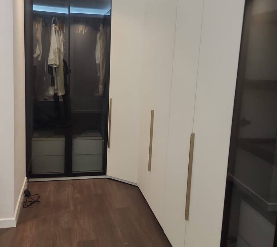 Giyinme odası — siyah profilli camlı dolaplar ve mat beyaz boy dolap sırası